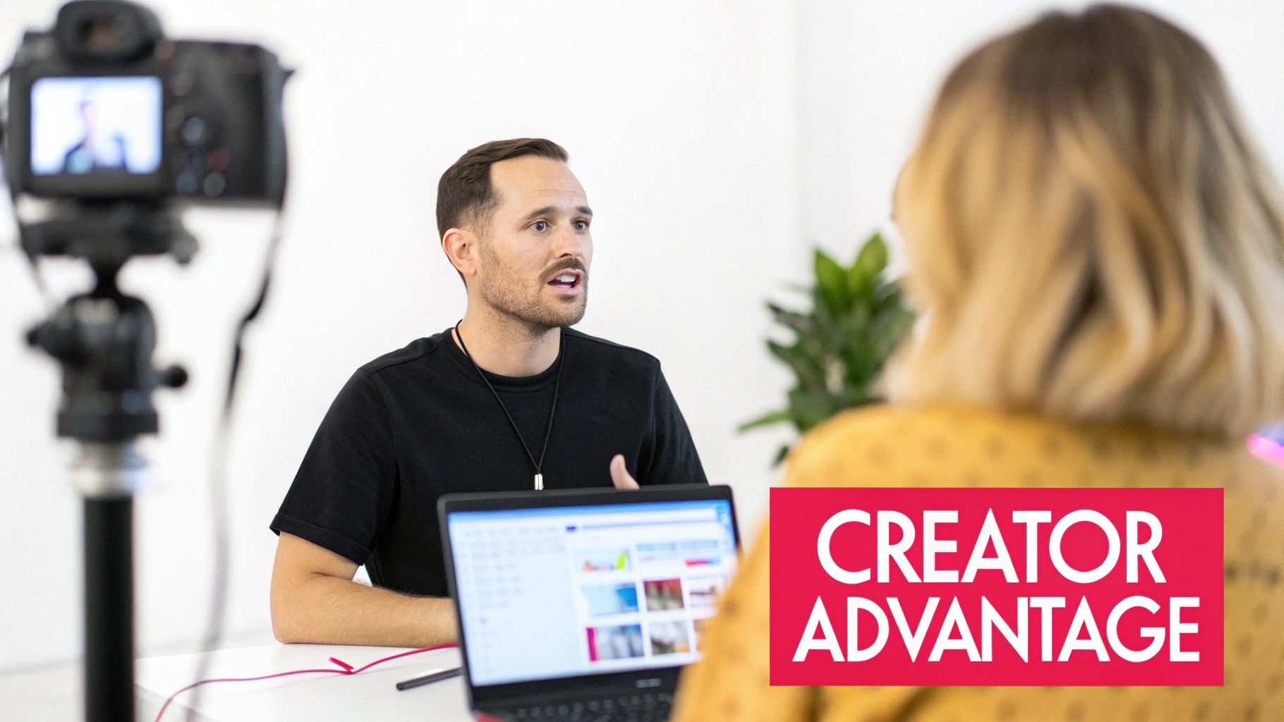 Man being filmed by a camera while speaking to another person during a video interview.