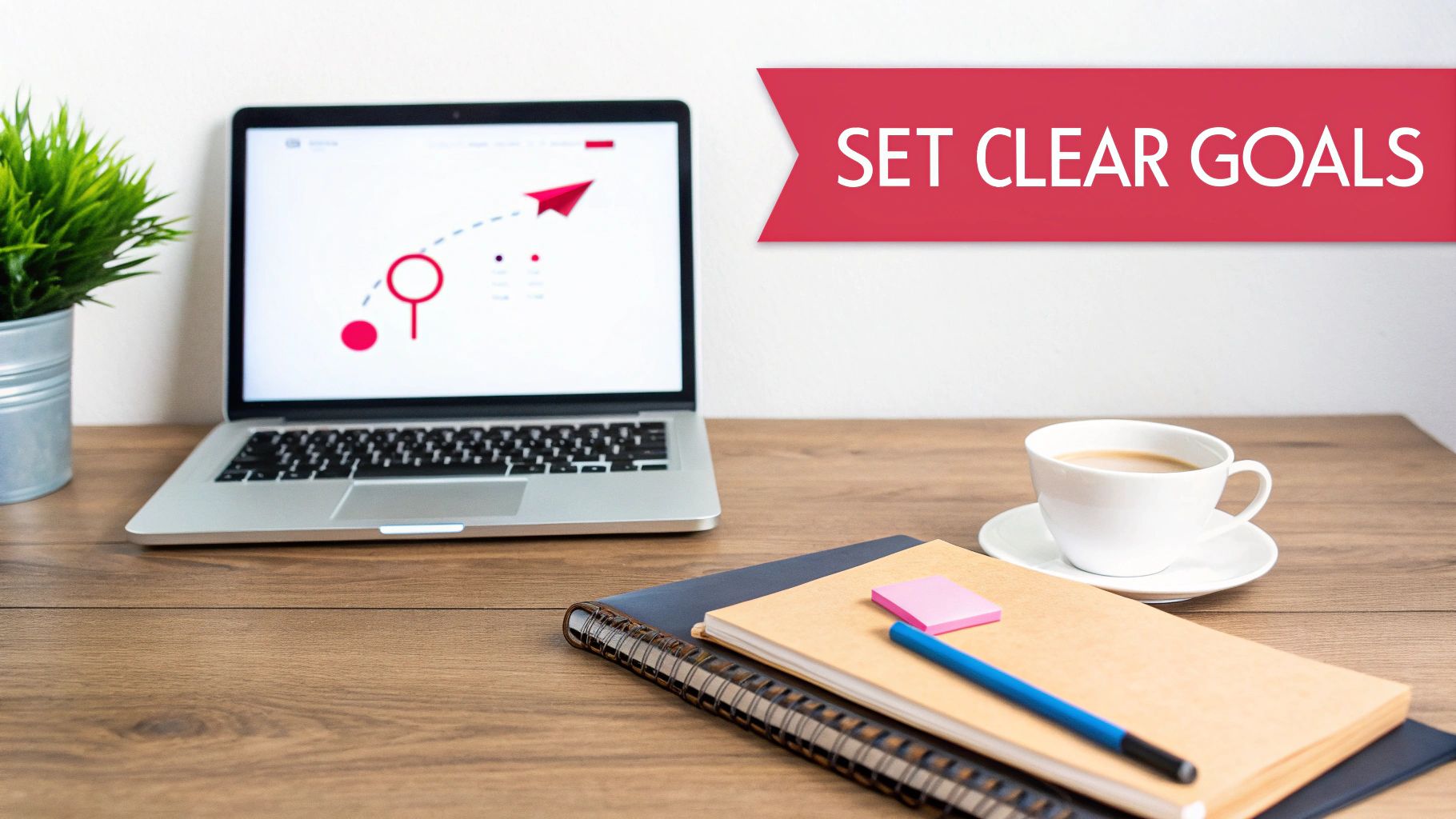 Desk setup with a laptop, coffee, and notebooks, accompanied by a 'SET CLEAR GOALS' banner.