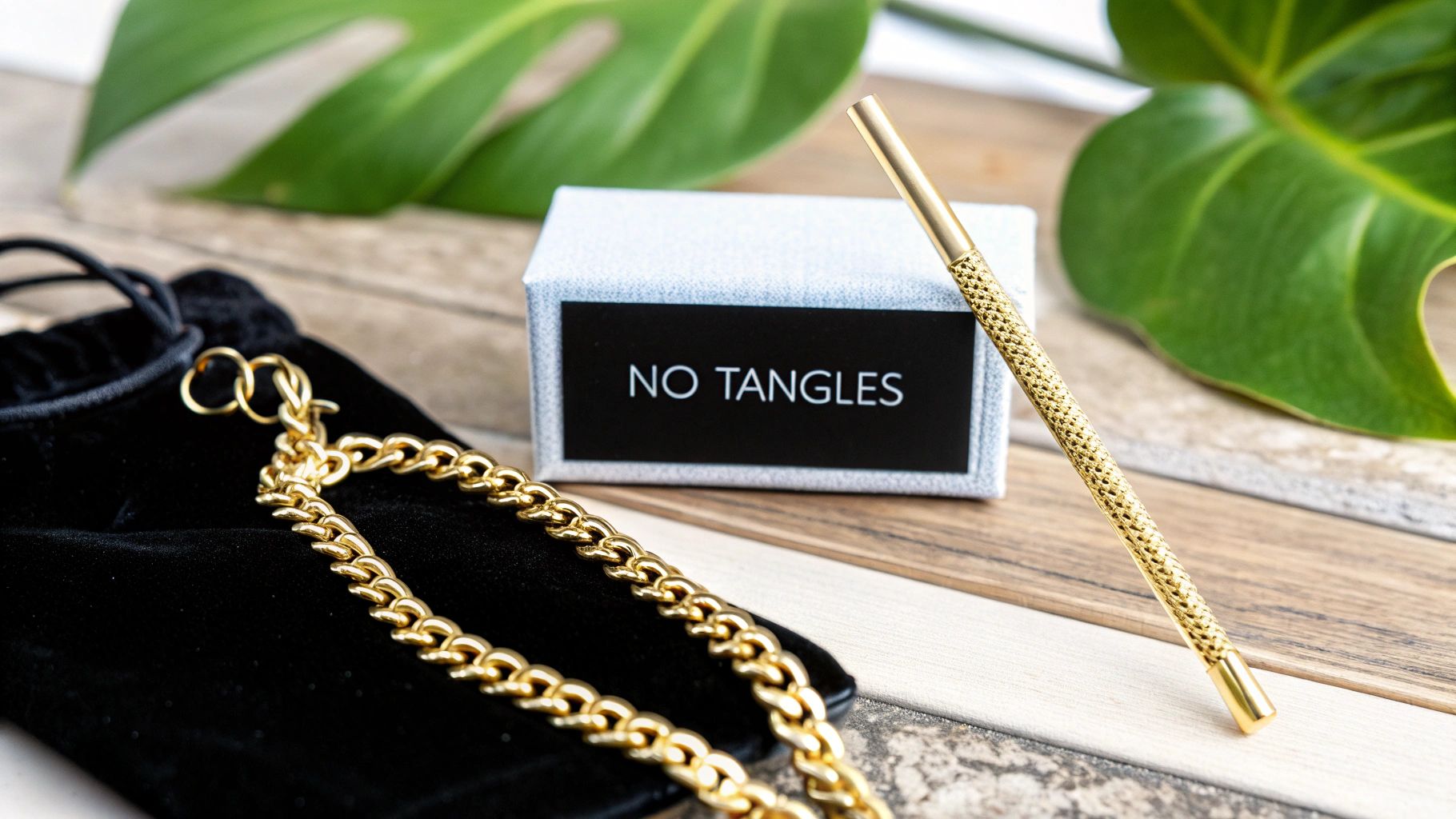 A woman carefully placing a gold necklace into a jewelry organizer.