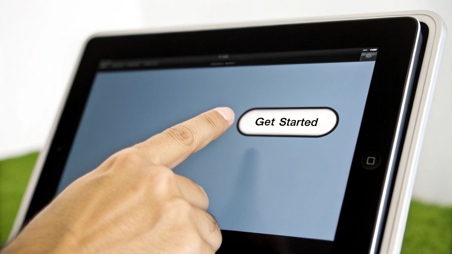 A finger taps a 'Get Started' button on a tablet screen, encouraging user interaction.
