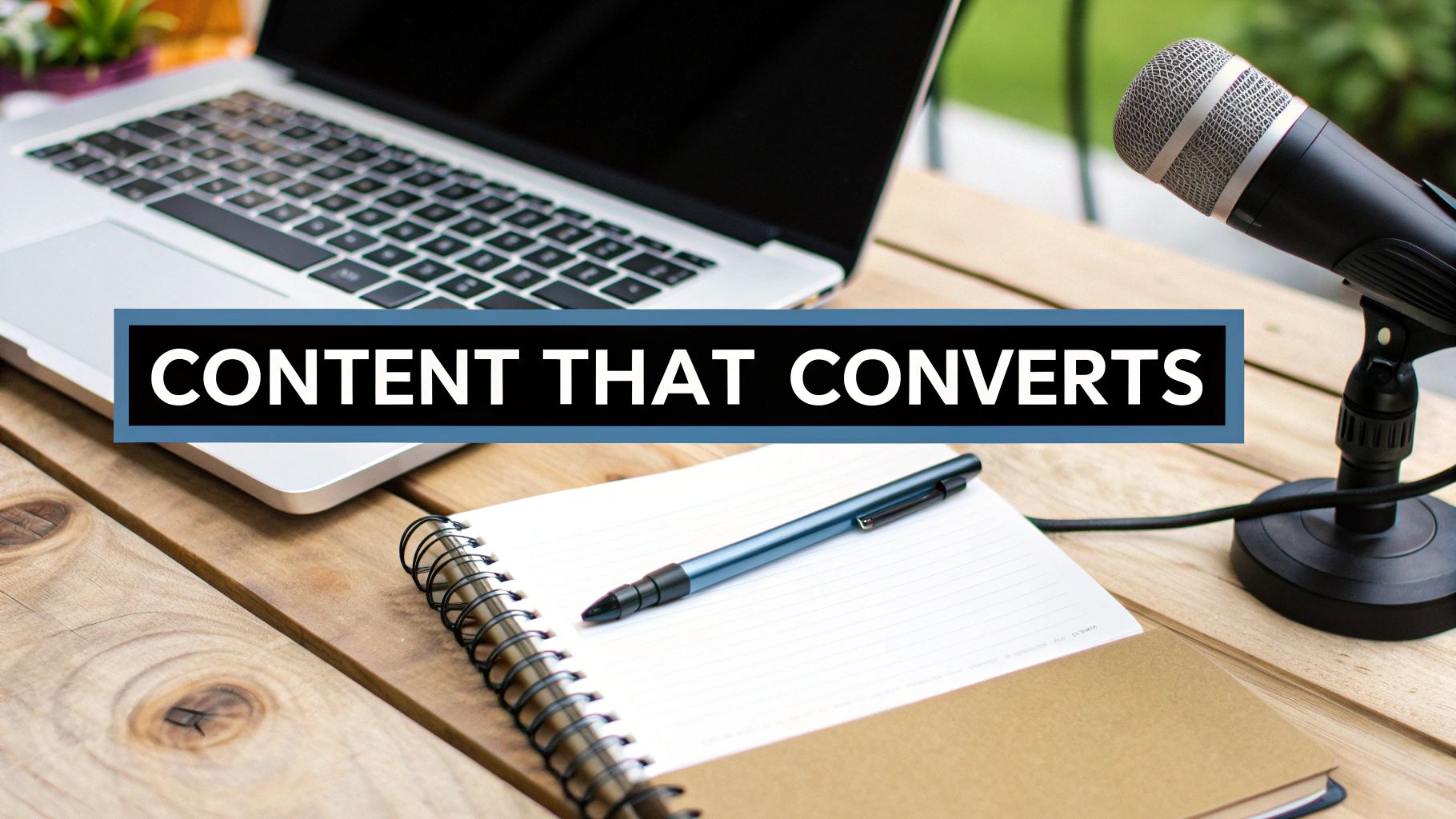 People collaborating on content creation around a large desk with sticky notes and laptops