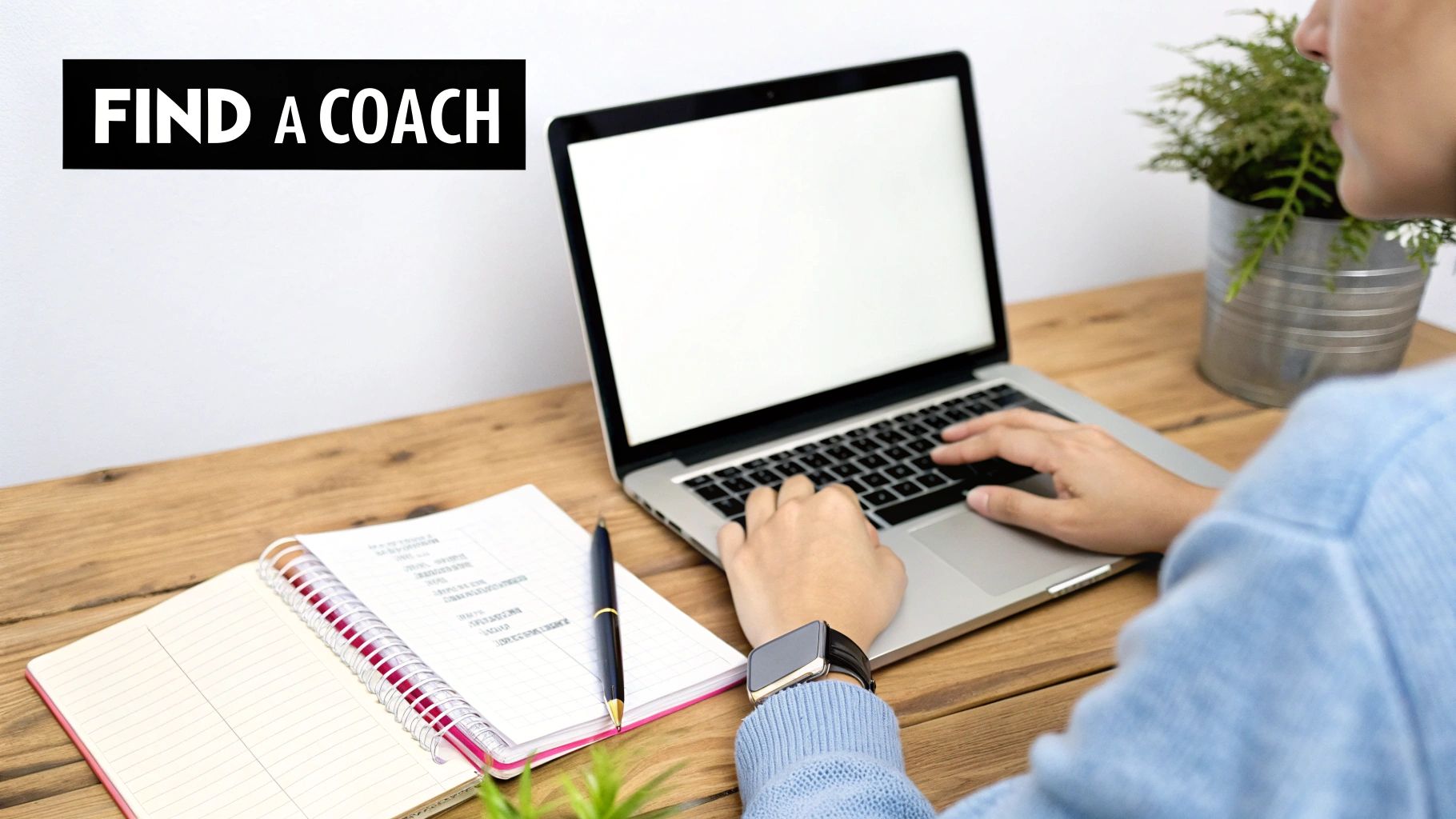 A person typing on a laptop next to an open notebook and a plant, with 'FIND A COACH' text overlay.
