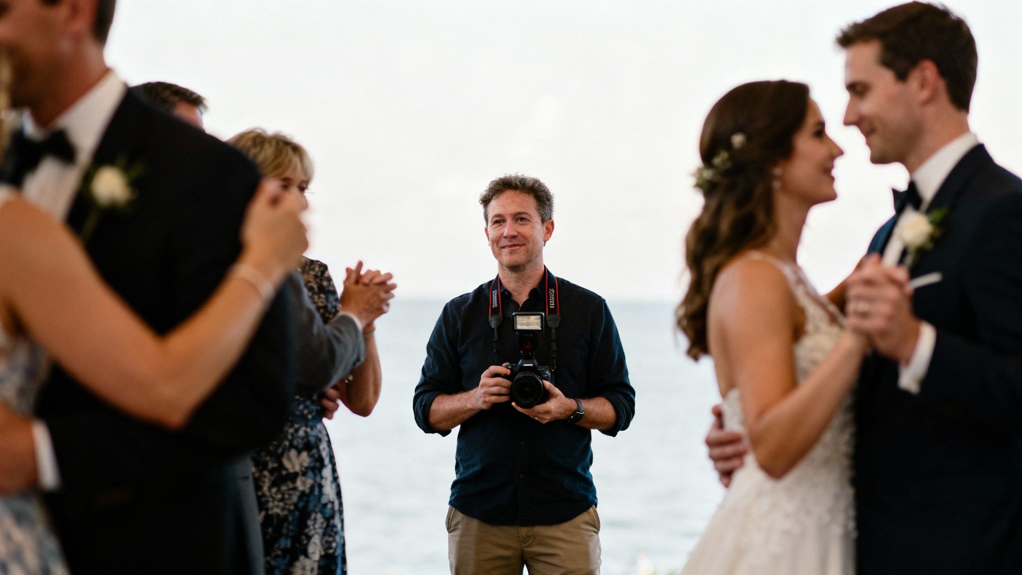 A bride and groom sharing a laugh during their wedding reception, captured in a candid style.