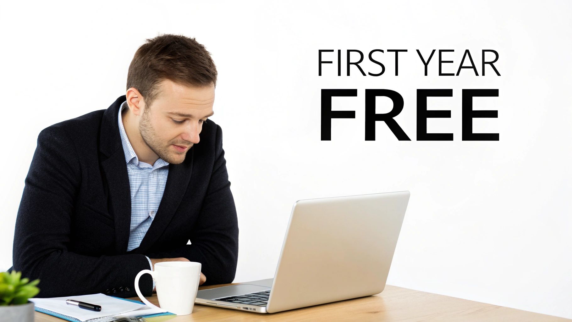 A man in a suit looking at his laptop, with 'FIRST YEAR FREE' text displayed, suggesting a special offer.