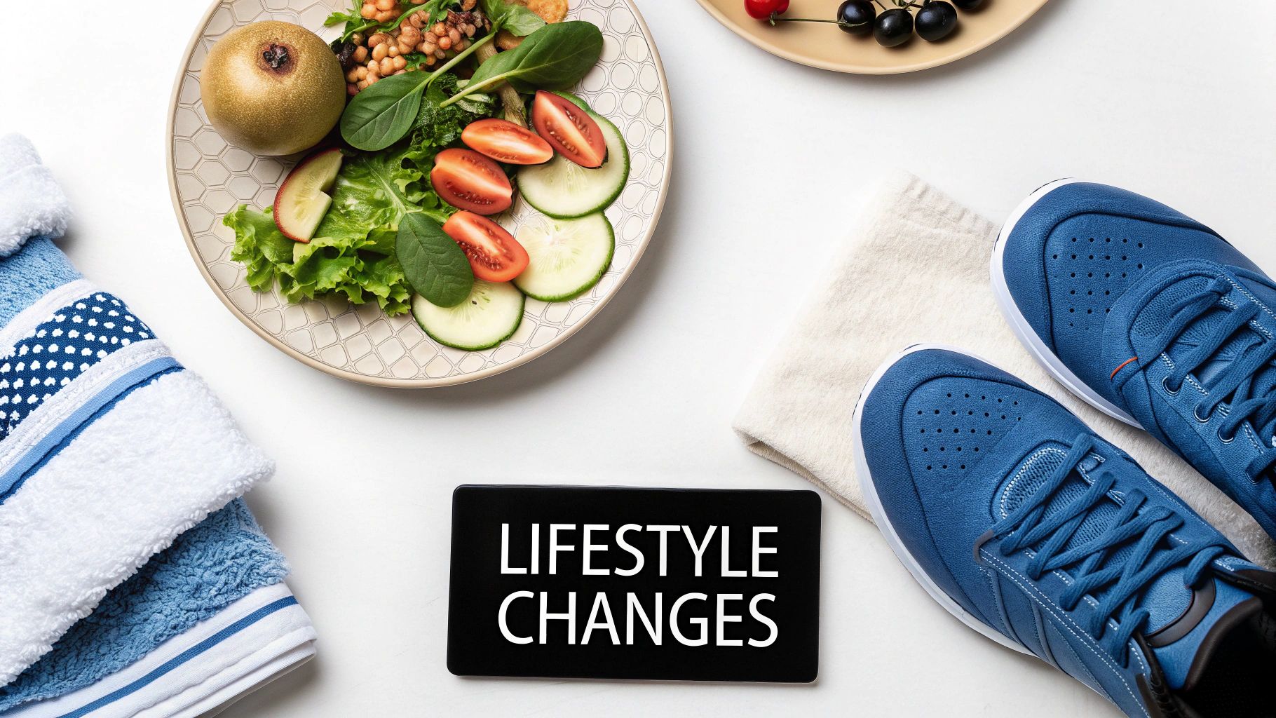 A flat lay showing a healthy meal, athletic shoes, towels, and a sign 'LIFESTYLE CHANGES'.