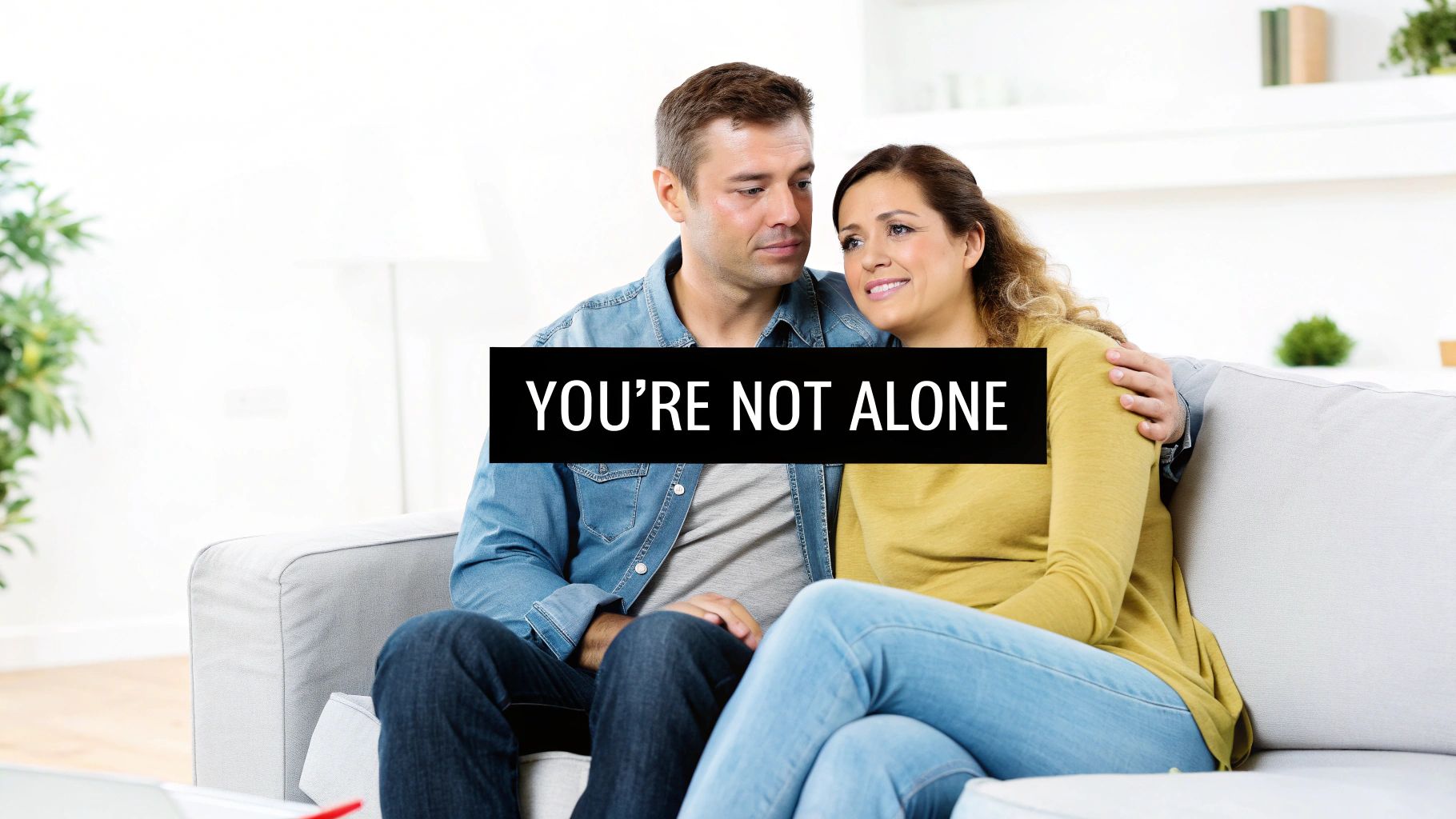 A thoughtful man sitting on a couch, representing someone considering their treatment options.