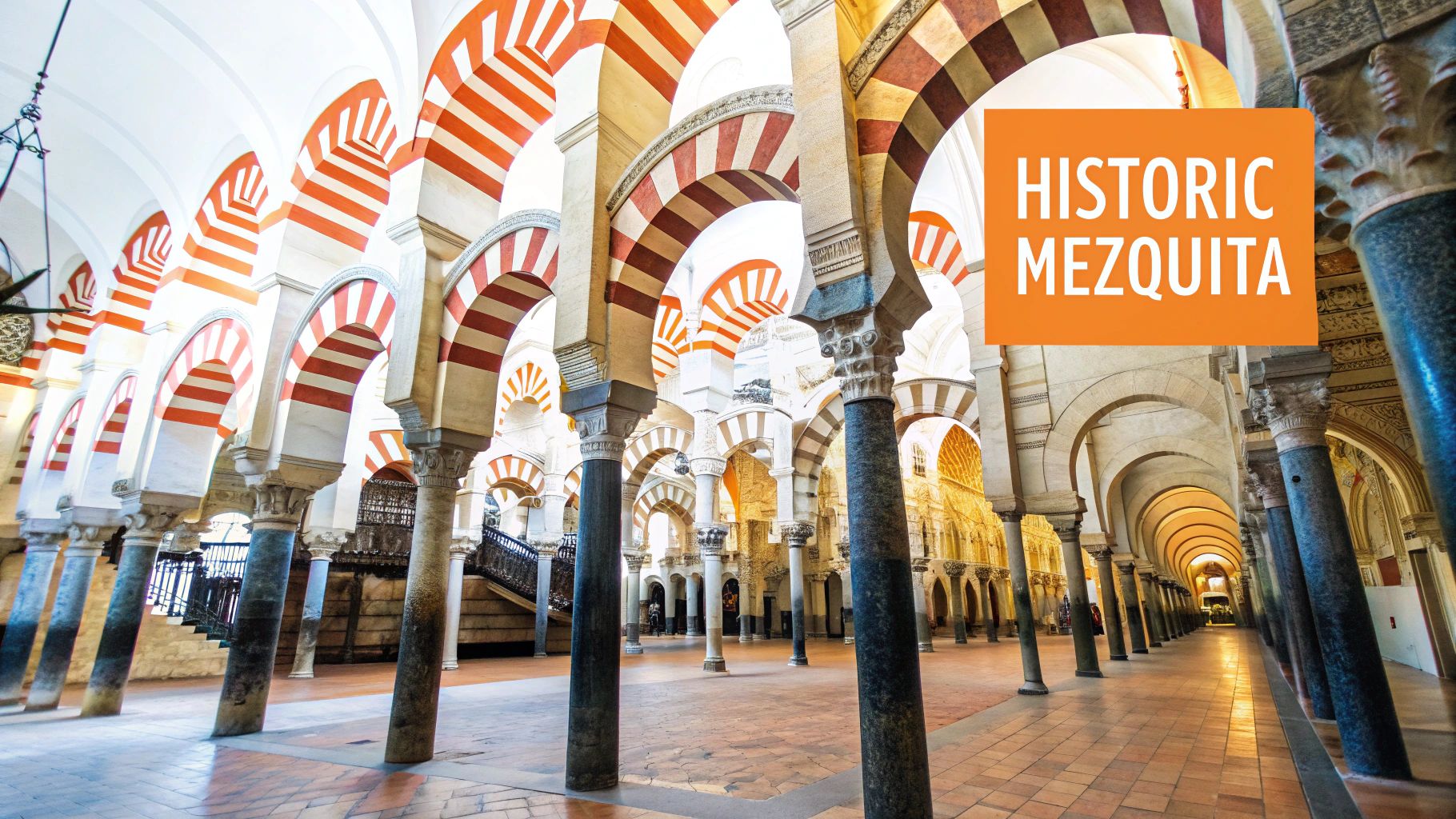 Interior view of the historic Mezquita-Cathedral in Cordoba, Spain, with countless red-and-white striped arches.