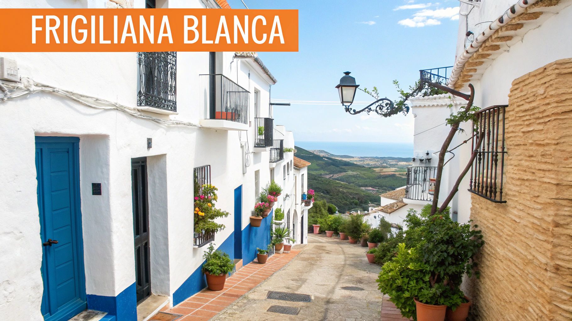 Calle pintoresca de Frigiliana Blanca con casas blancas, detalles azules y vistas al mar Mediterráneo