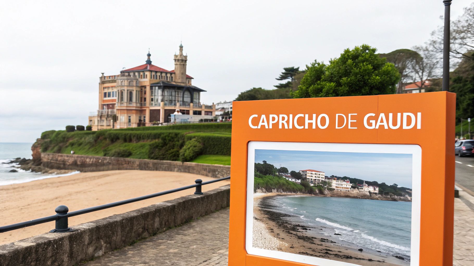 Vista de El Capricho de Gaudí sobre un acantilado junto a una playa de Cantabria, con un cartel informativo en primer plano.