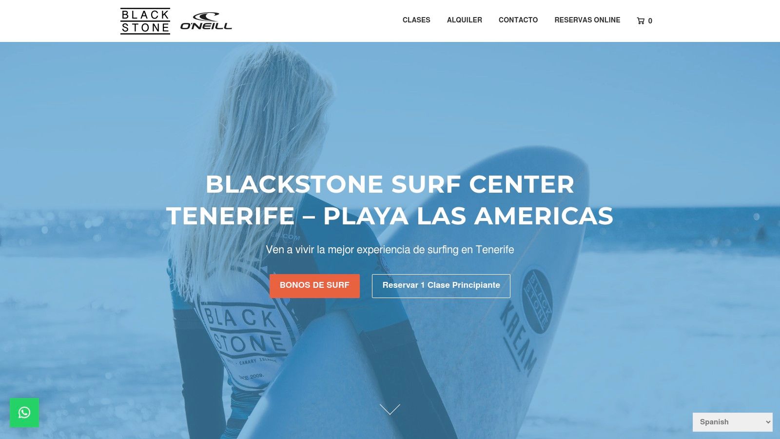 A person holding a surfboard at a surf school in Tenerife