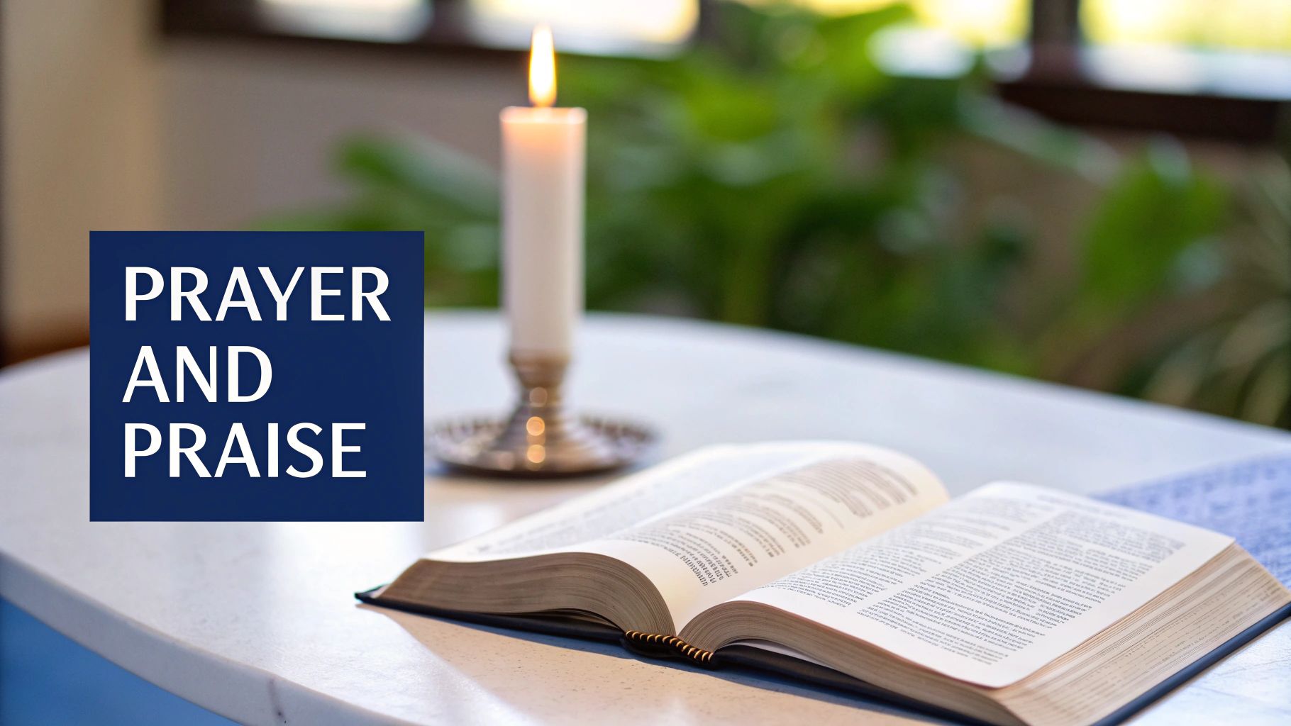 Open Bible with lit candle on table beside prayer and praise text for worship