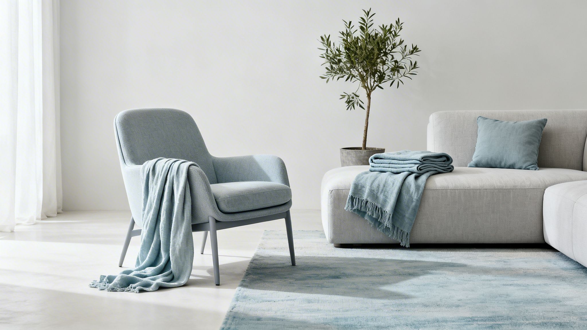 A minimalist living room featuring a light blue armchair, a grey sofa with blue accents, and an olive tree.