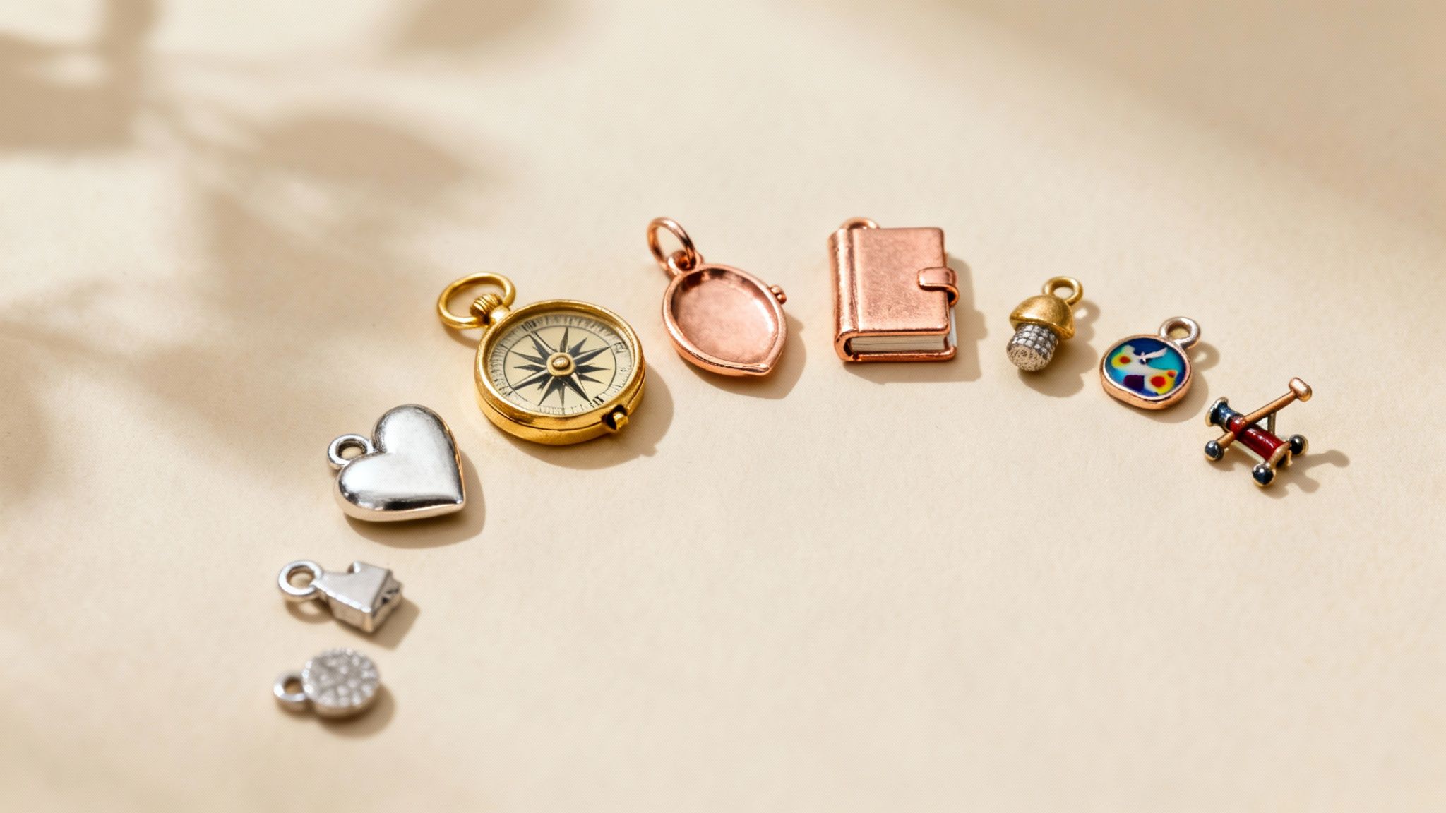 A collection of intricate silver charms spread out, ready to be added to a bracelet