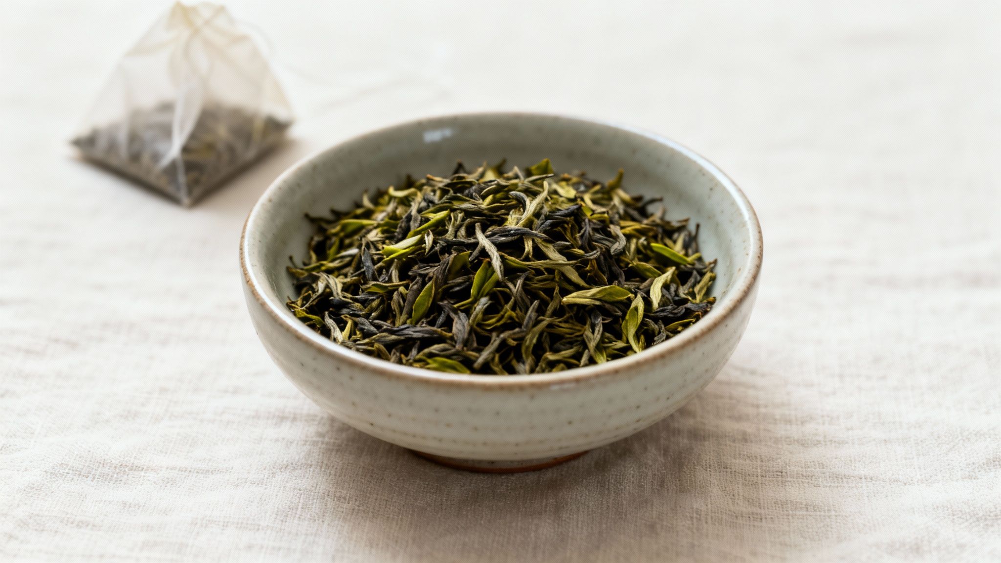 An artful arrangement of various loose leaf teas in small bowls, showcasing their diverse colours and textures.