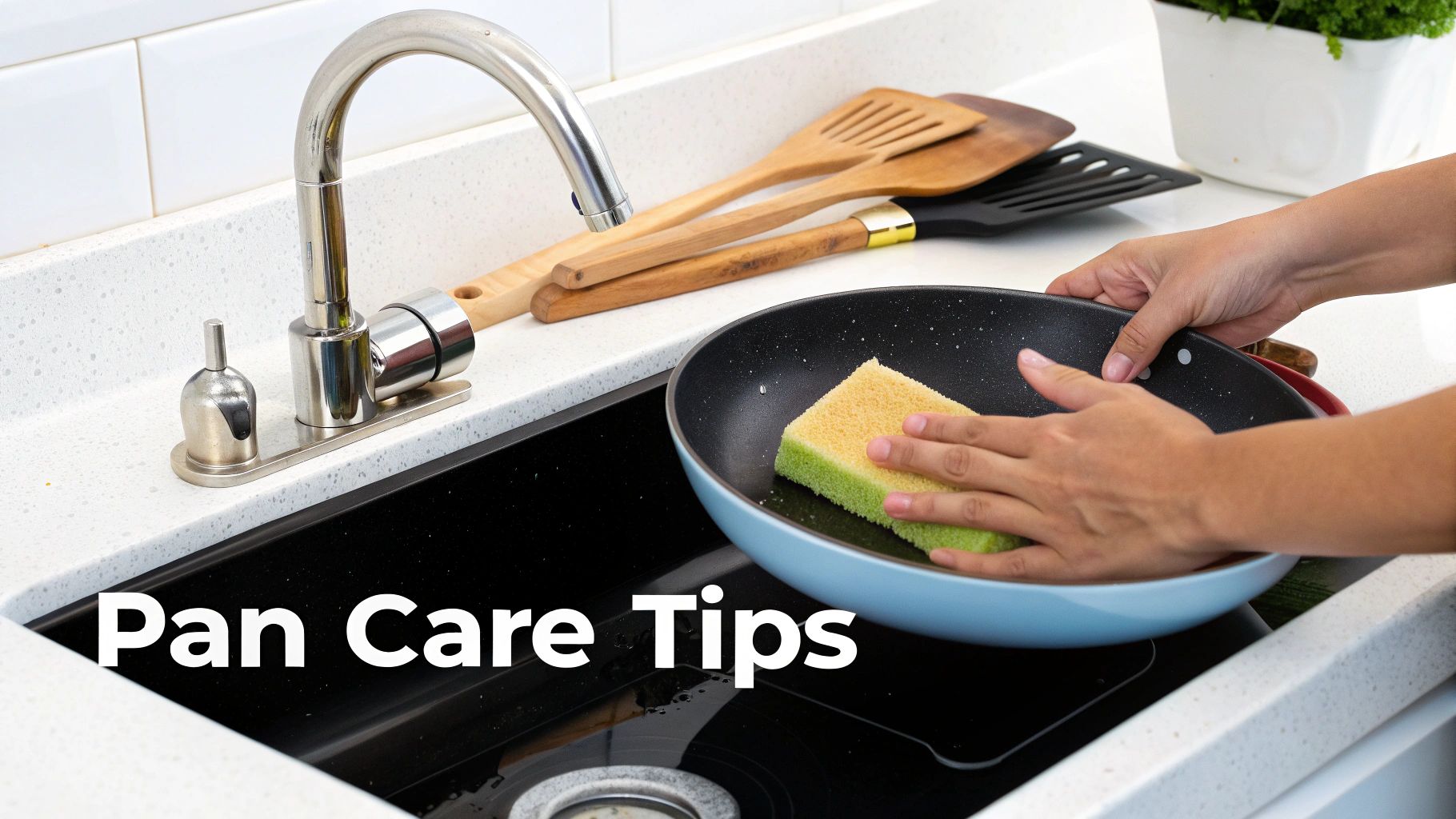 A person cleans a black non-stick frying pan with a sponge in a modern kitchen sink.