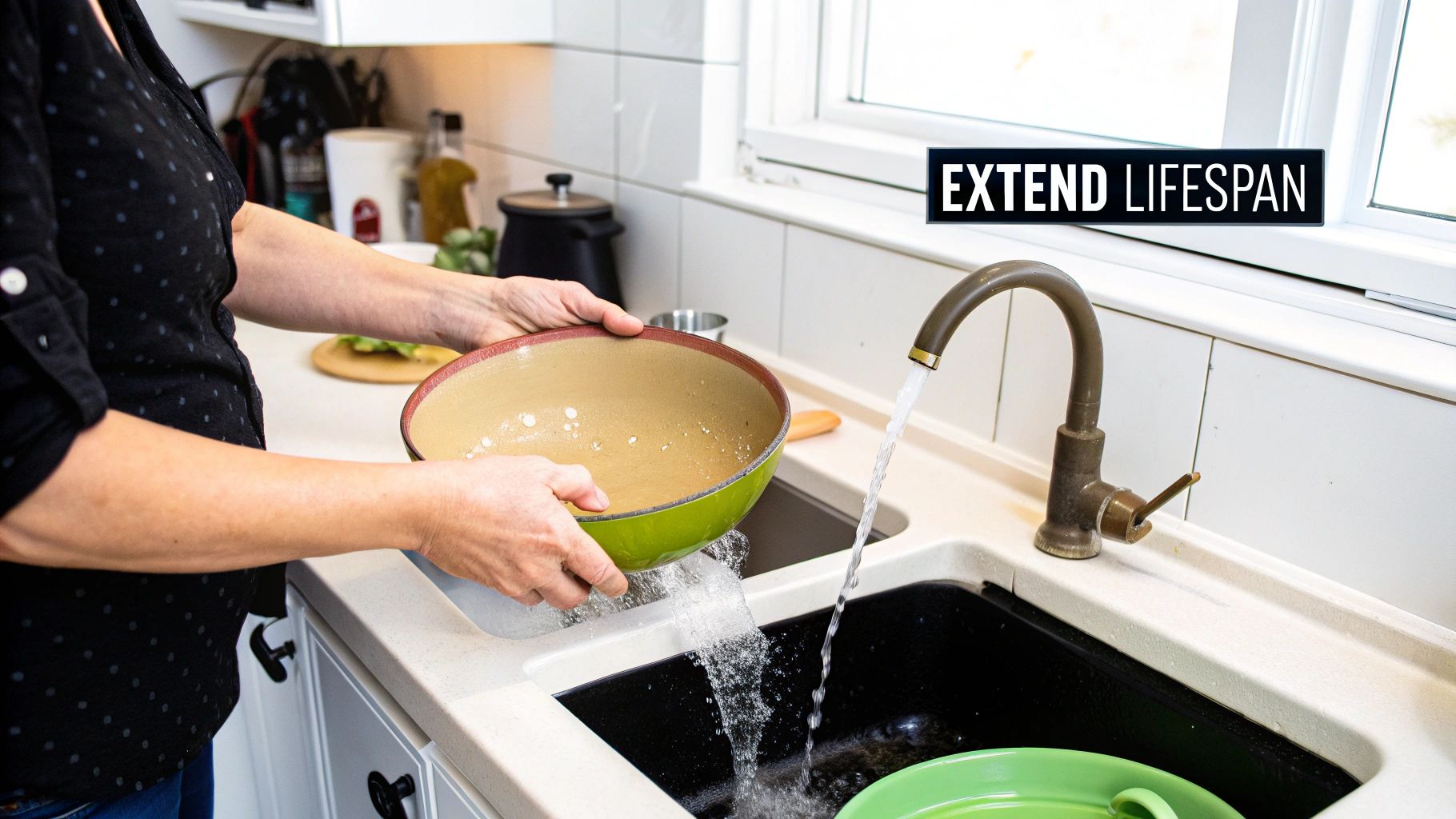 A person carefully hand washing a ceramic pan in a kitchen sink.