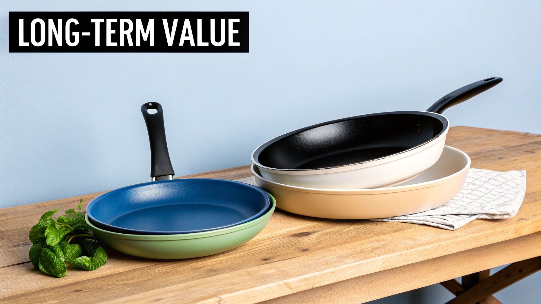 A stack of colorful ceramic frying pans and cooking pots on a wooden table, with fresh mint.