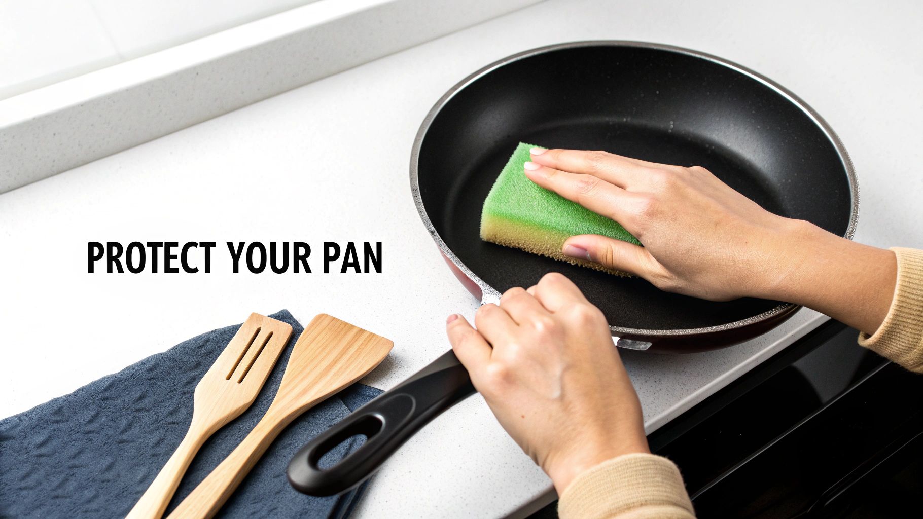 A person carefully hand-washing a titanium pan in a kitchen sink.
