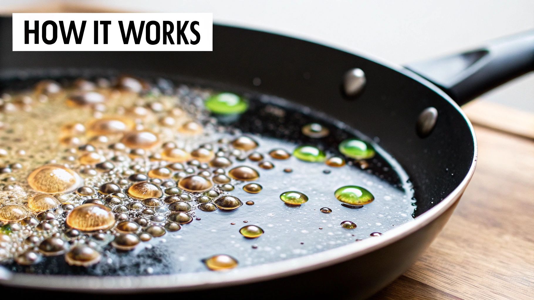 Bubbling golden liquid and vibrant green drops in a black non-stick skillet pan.