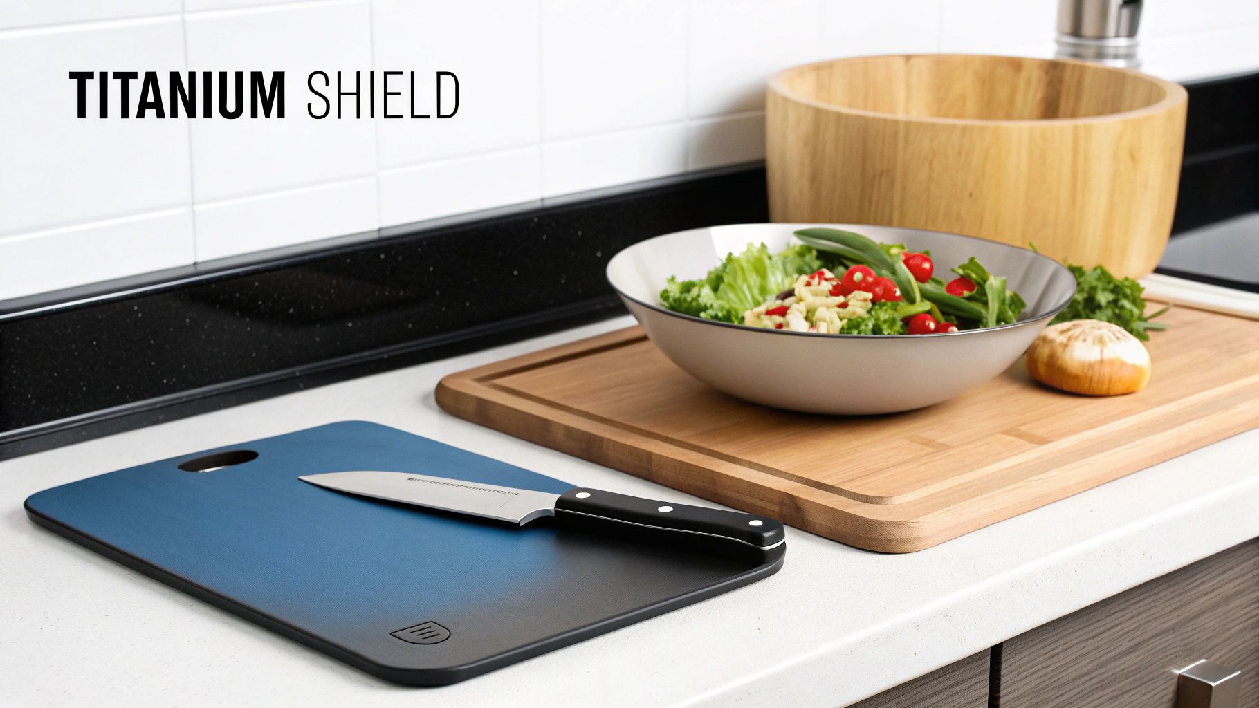 A modern kitchen counter displaying cutting boards, a knife, a fresh salad, and wooden bowls.