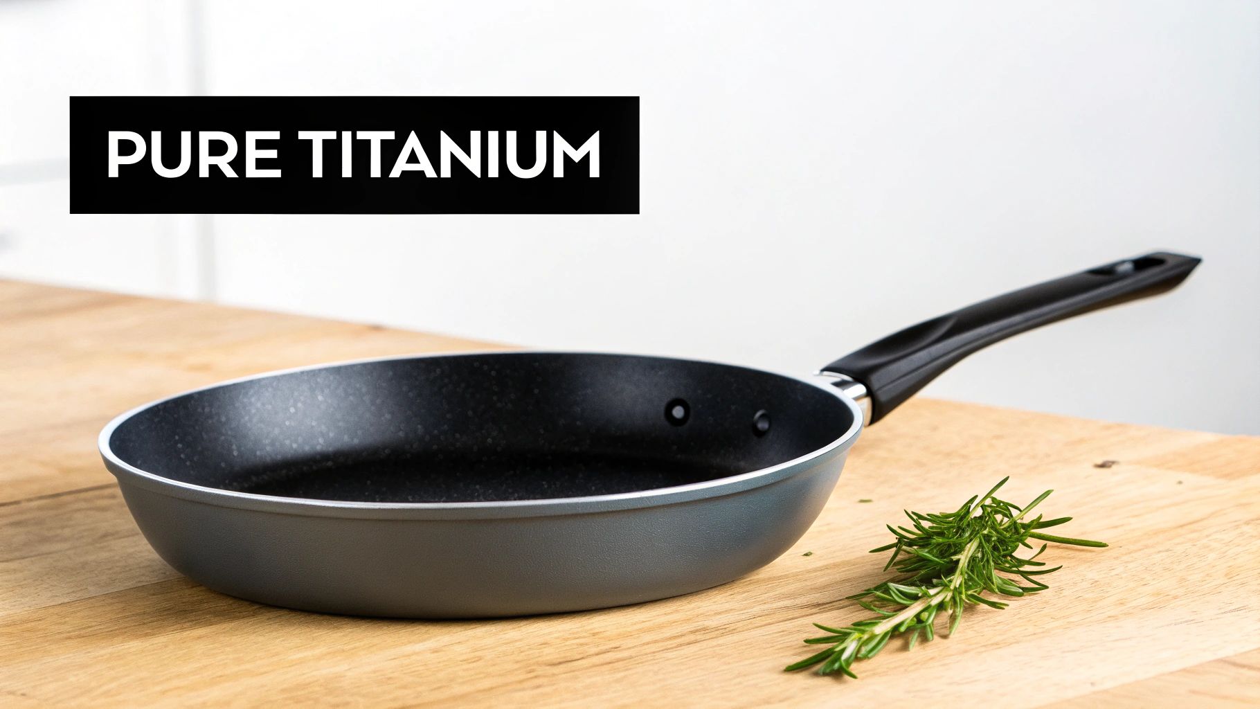 A set of modern, pure titanium cookware pieces arranged neatly on a clean surface.