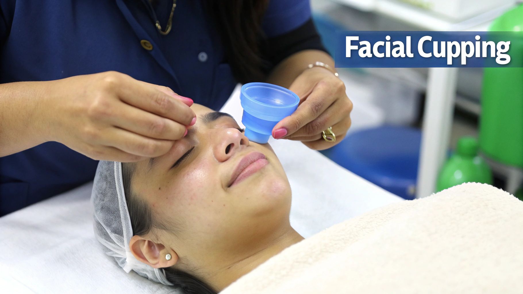 A therapist performs facial cupping on a woman, applying a small blue silicone cup to her face.