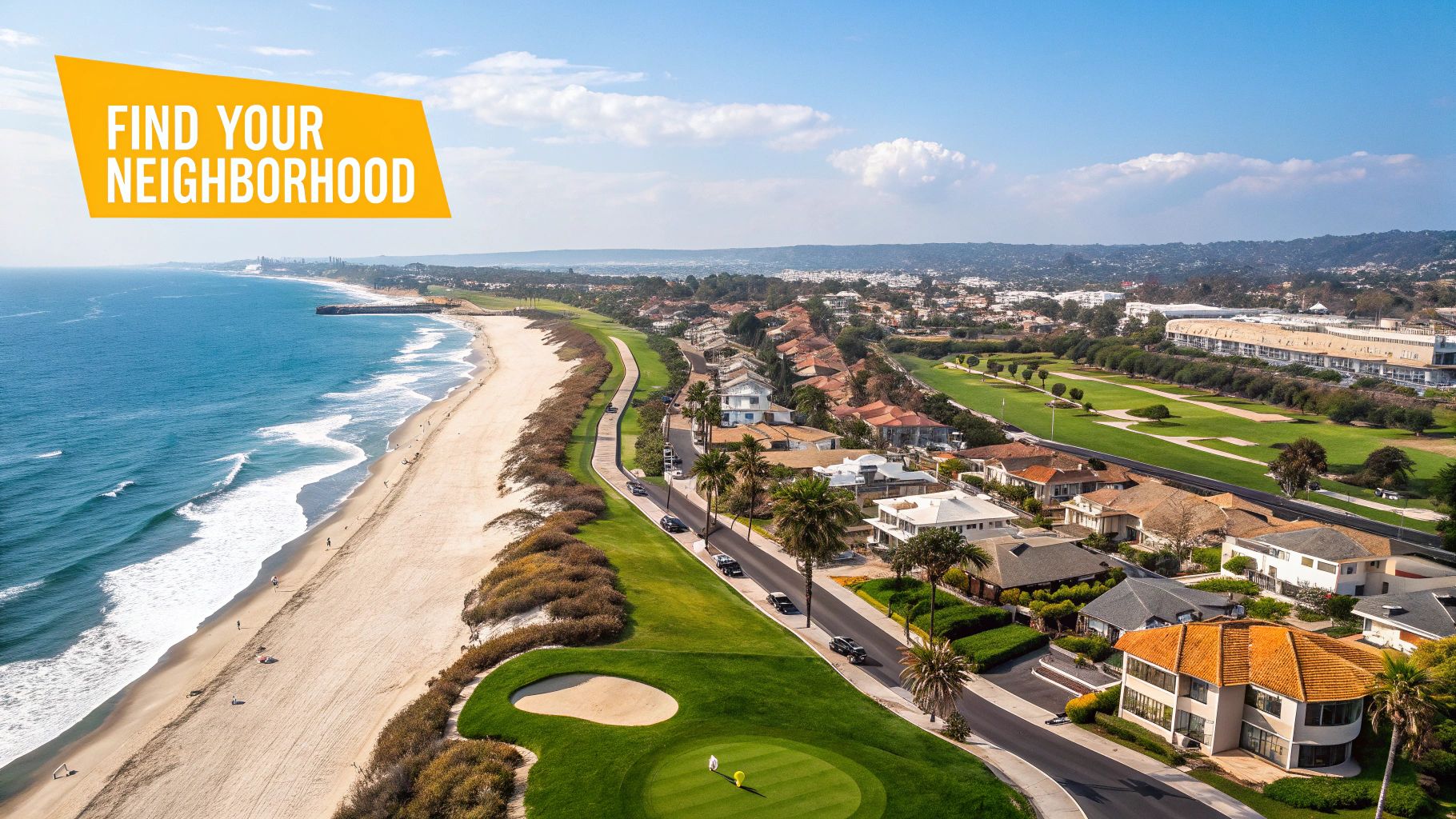 Aerial view of a vibrant coastal neighborhood featuring a beach, ocean, golf course, and houses under a clear blue sky.