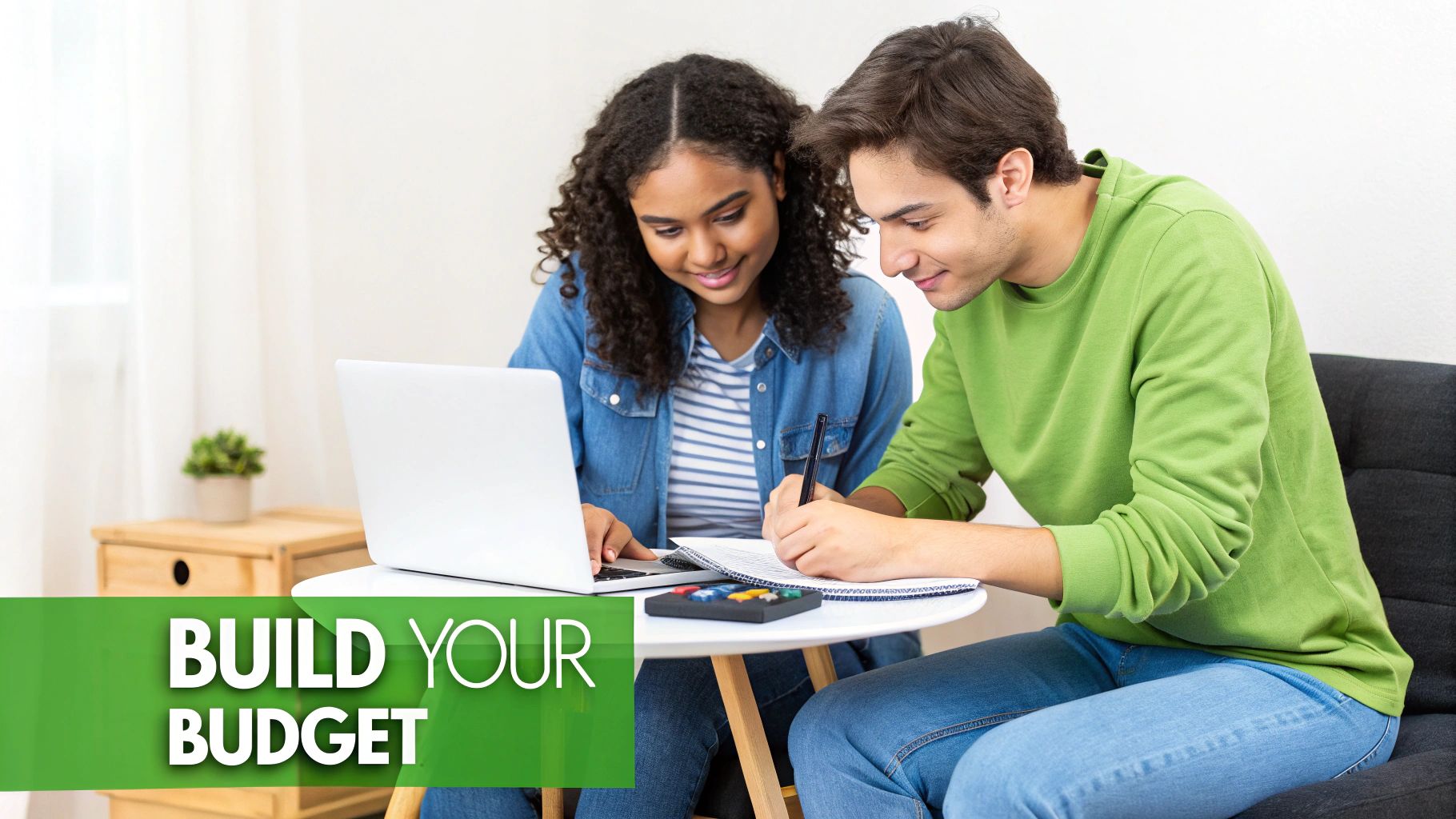 Two young people, a man and a woman, collaborating on budgeting with a laptop and notebook.