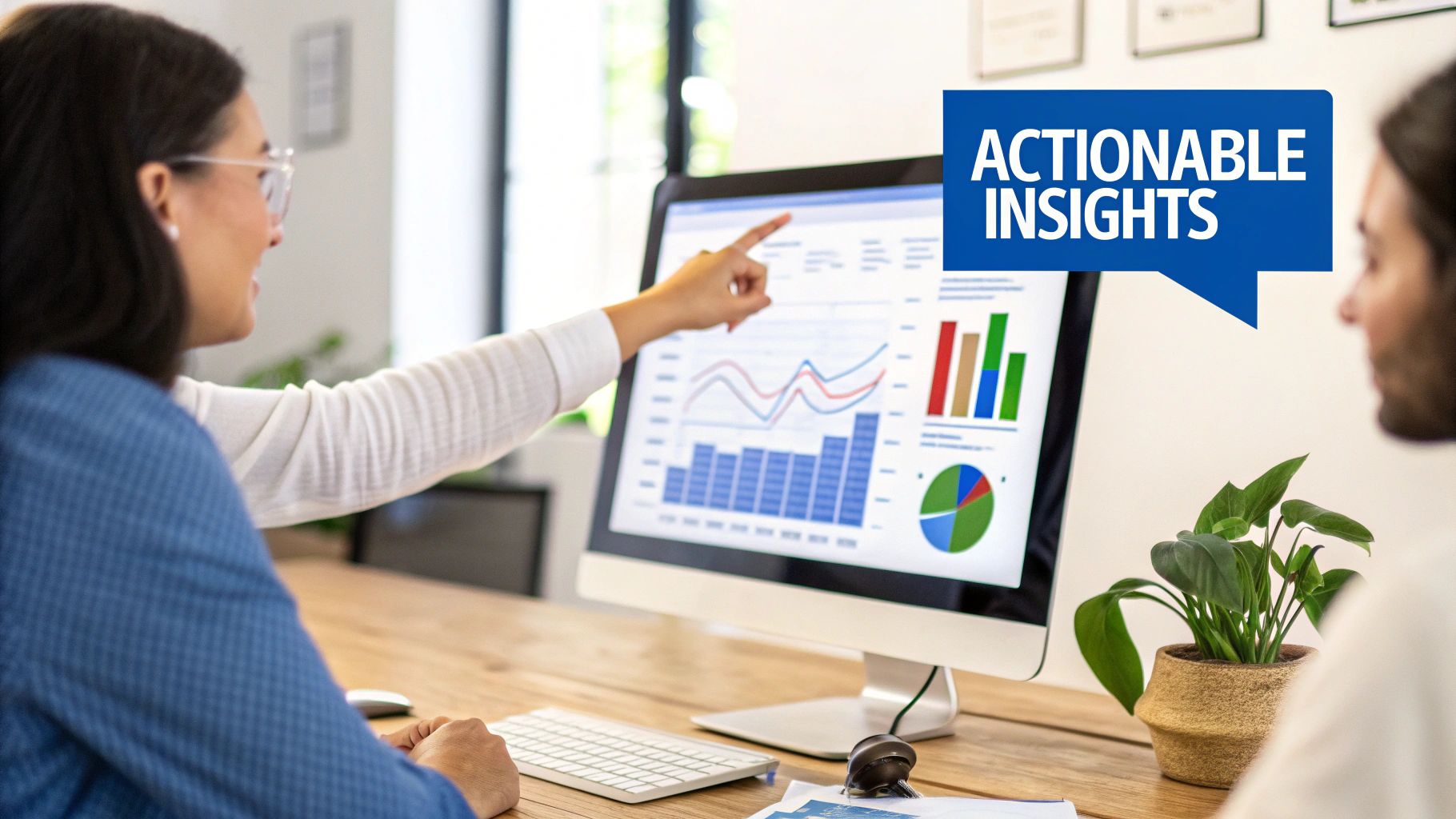 A person working at a desk with Salesforce and HubSpot logos on their screen, representing the implementation process.
