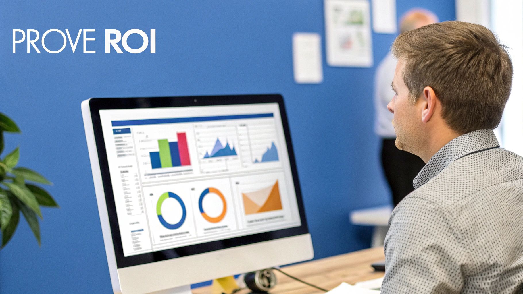 A man analyzes data dashboards and charts on a computer screen to prove ROI in an office setting.