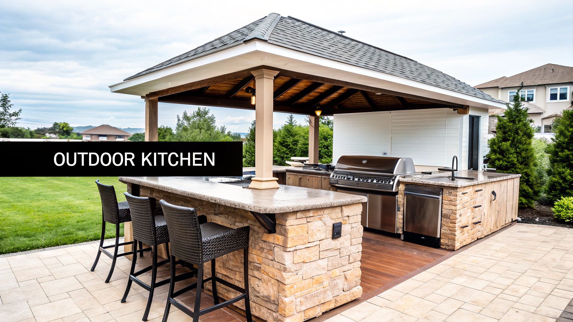 An elegant outdoor kitchen under a covered gazebo, featuring a grill, sink, and bar seating.