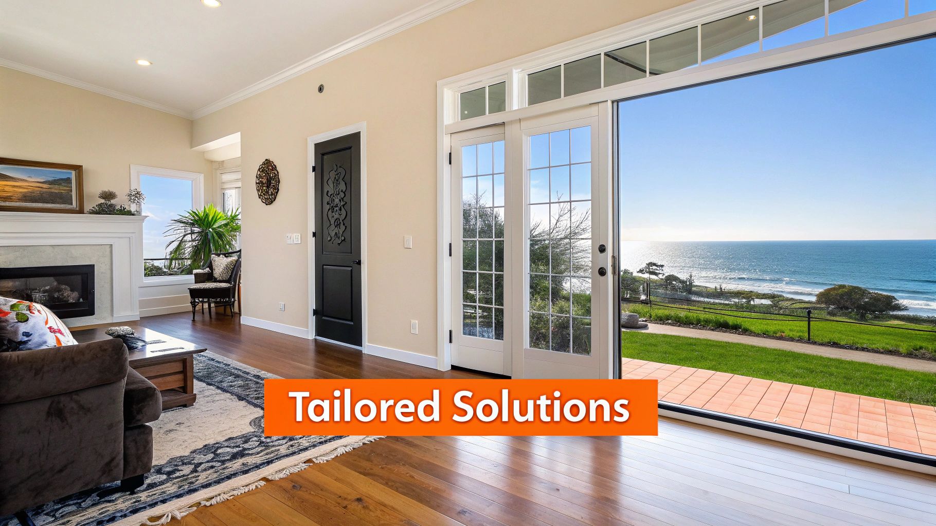 A luxurious living room with wood floors and a fireplace, opening to a stunning ocean view.