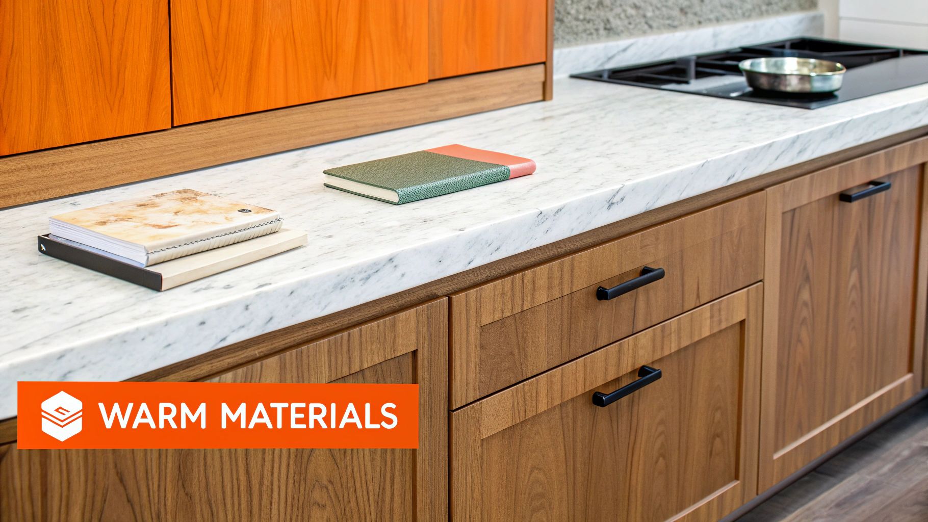Warm kitchen design featuring natural wood cabinetry, marble countertop, and stylish notebooks, reflecting California's trend towards authentic, inviting spaces.