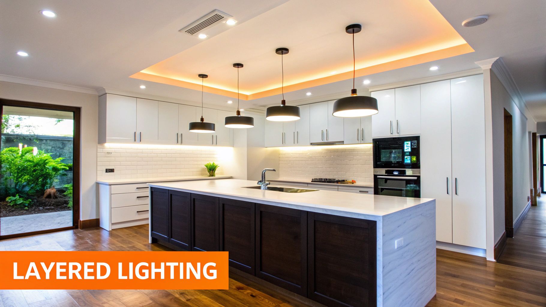 A modern kitchen showcasing layered lighting, including recessed, pendant, and under-cabinet fixtures.