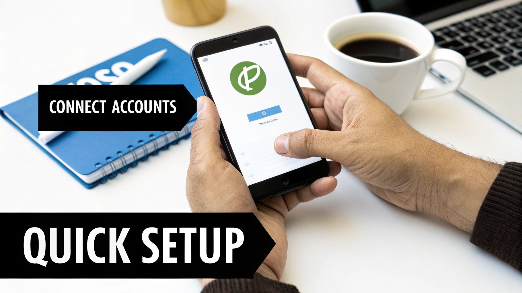 Person's hands using a smartphone to connect accounts quickly, with a notebook, coffee, and laptop nearby.