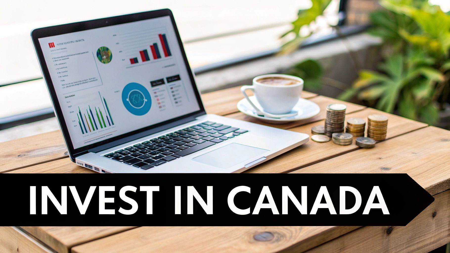 Laptop displaying investment charts, a coffee cup, and stacked coins on a wooden table.