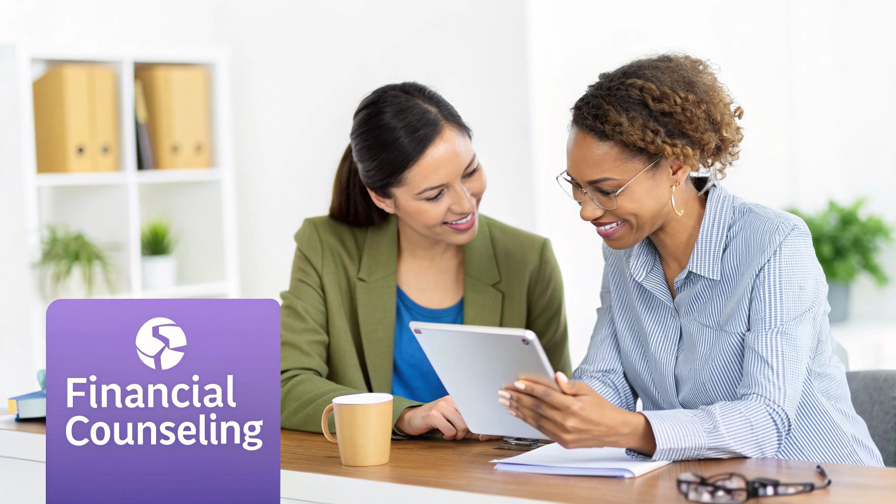 Two women, possibly financial counselors or clients, discussing information on a tablet with a 'Financial Counseling' logo.