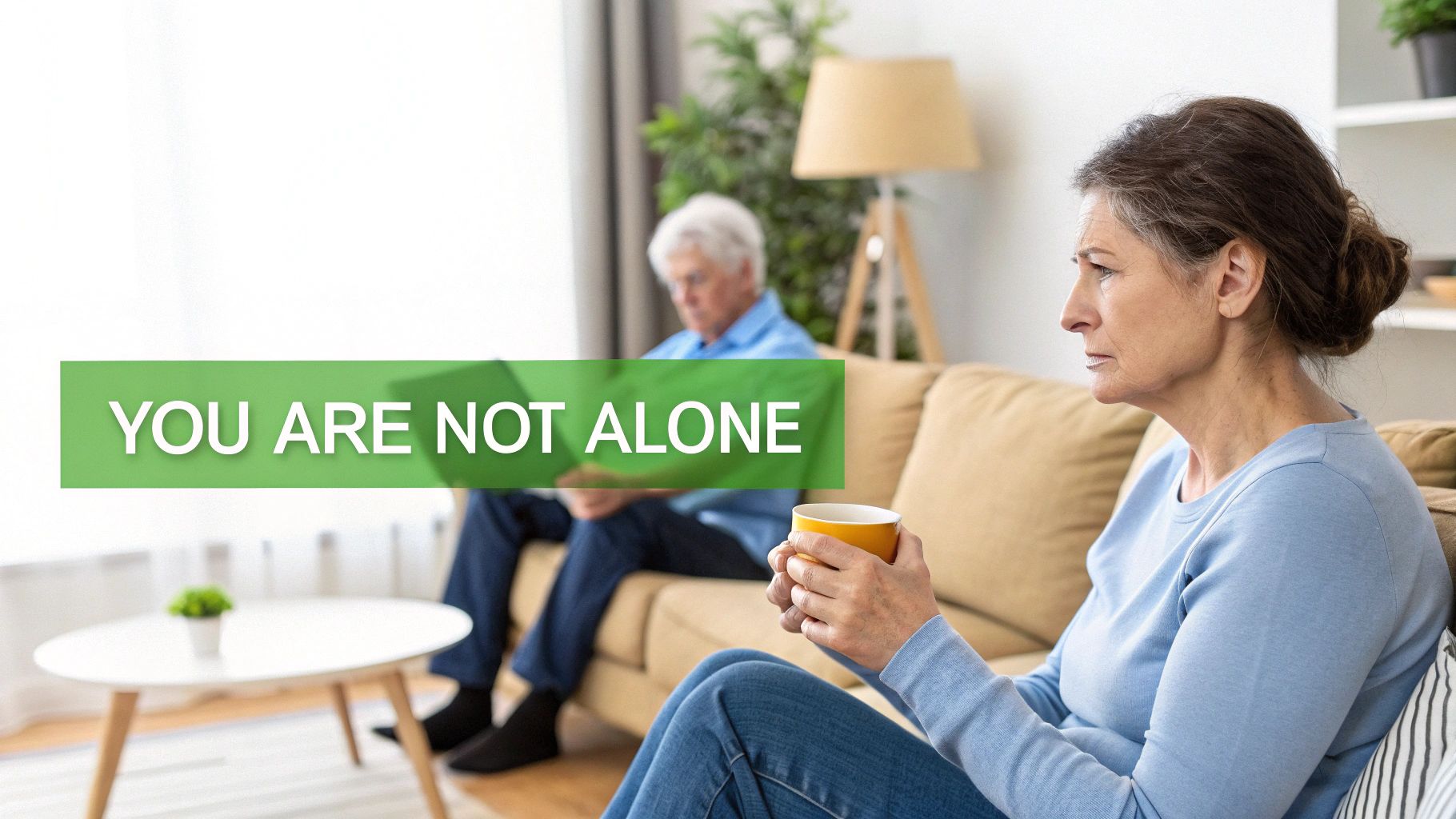 A solemn elderly woman holds a mug, with a man in the background, and 'YOU ARE NOT ALONE' text.