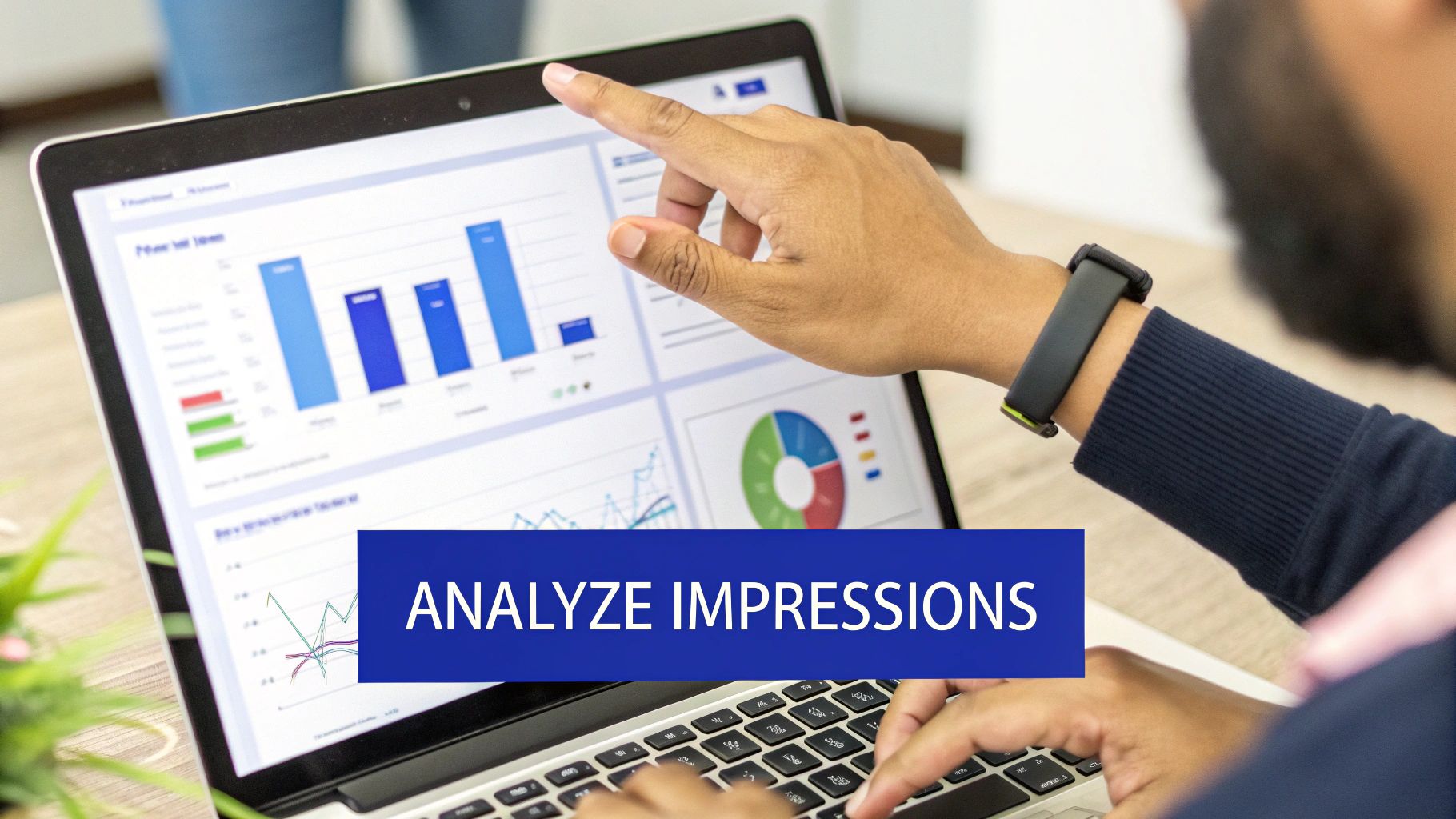 A person's hands interact with a laptop displaying data charts, pointing at the screen to analyze impressions.