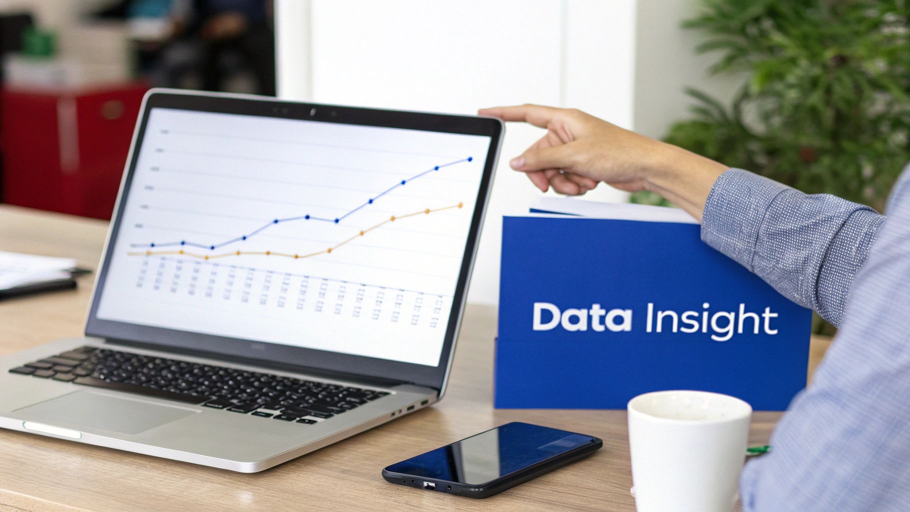 Person pointing at a laptop screen displaying a data graph, next to a 'Data Insight' folder.