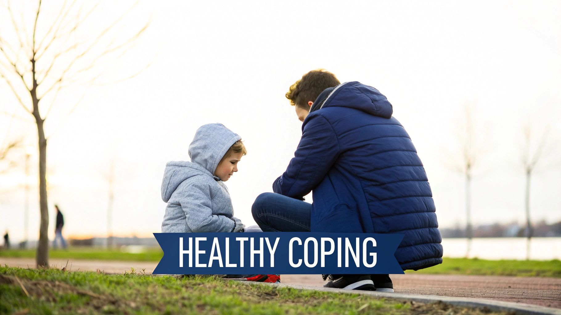 An adult and child in hooded jackets sit together on the ground outdoors with 'HEALTHY COPING' text.