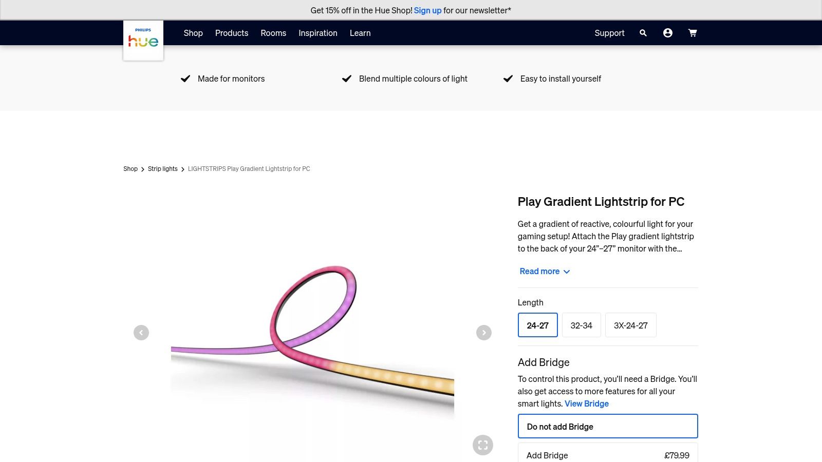 A Philips Hue Play Gradient Lightstrip attached to the back of a PC monitor, displaying a vibrant rainbow of colours that syncs with the on-screen image.