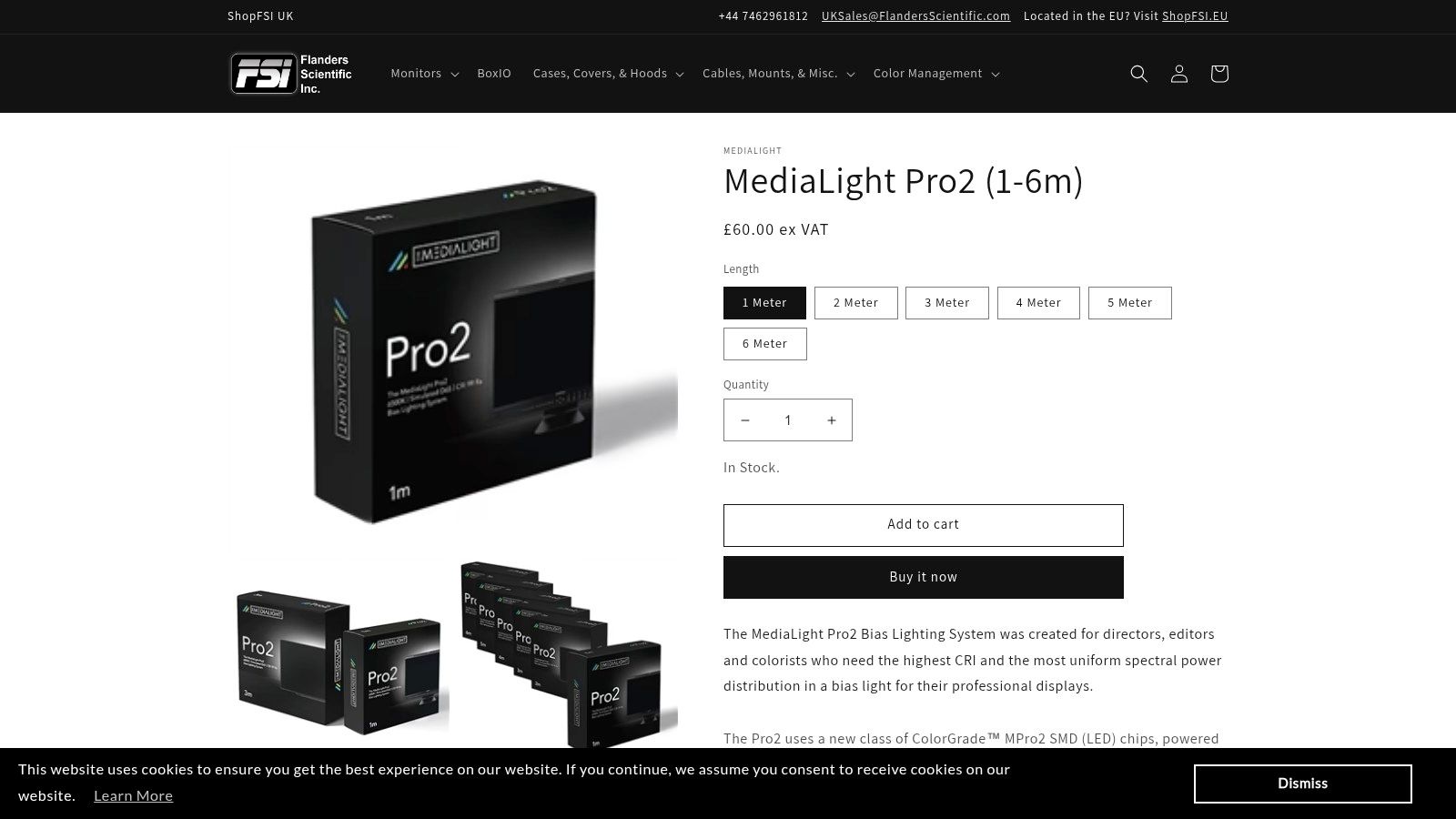A MediaLight Pro2 bias light installed on the back of a professional-grade monitor in a dark room, emitting a neutral white light.