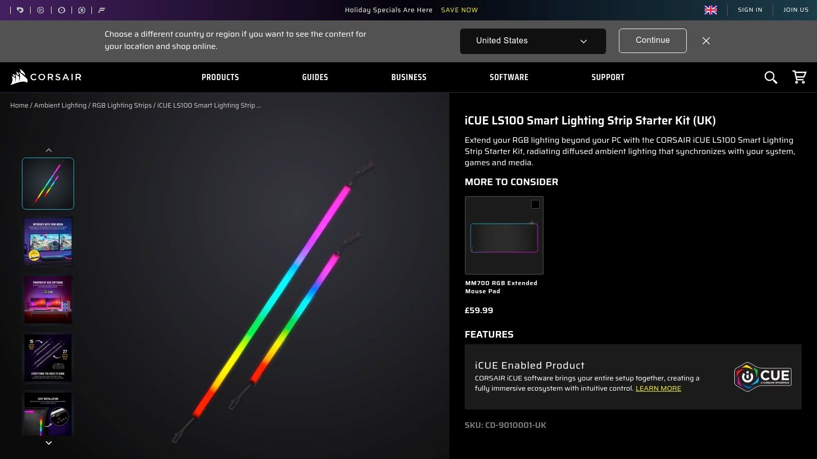 CORSAIR iCUE LS100 Smart Lighting Strips attached to the back of a PC monitor, casting a vibrant multi-coloured glow against the wall.