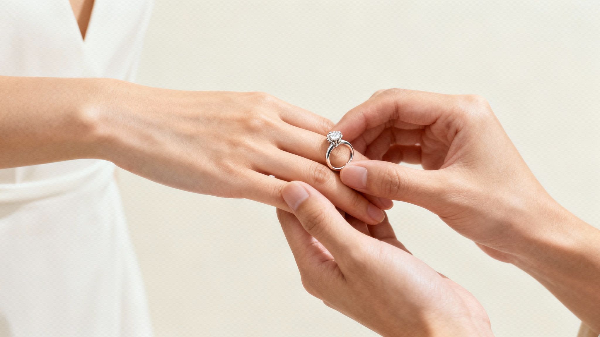 A close-up of a jeweller carefully working on resizing an engagement ring at their workbench.