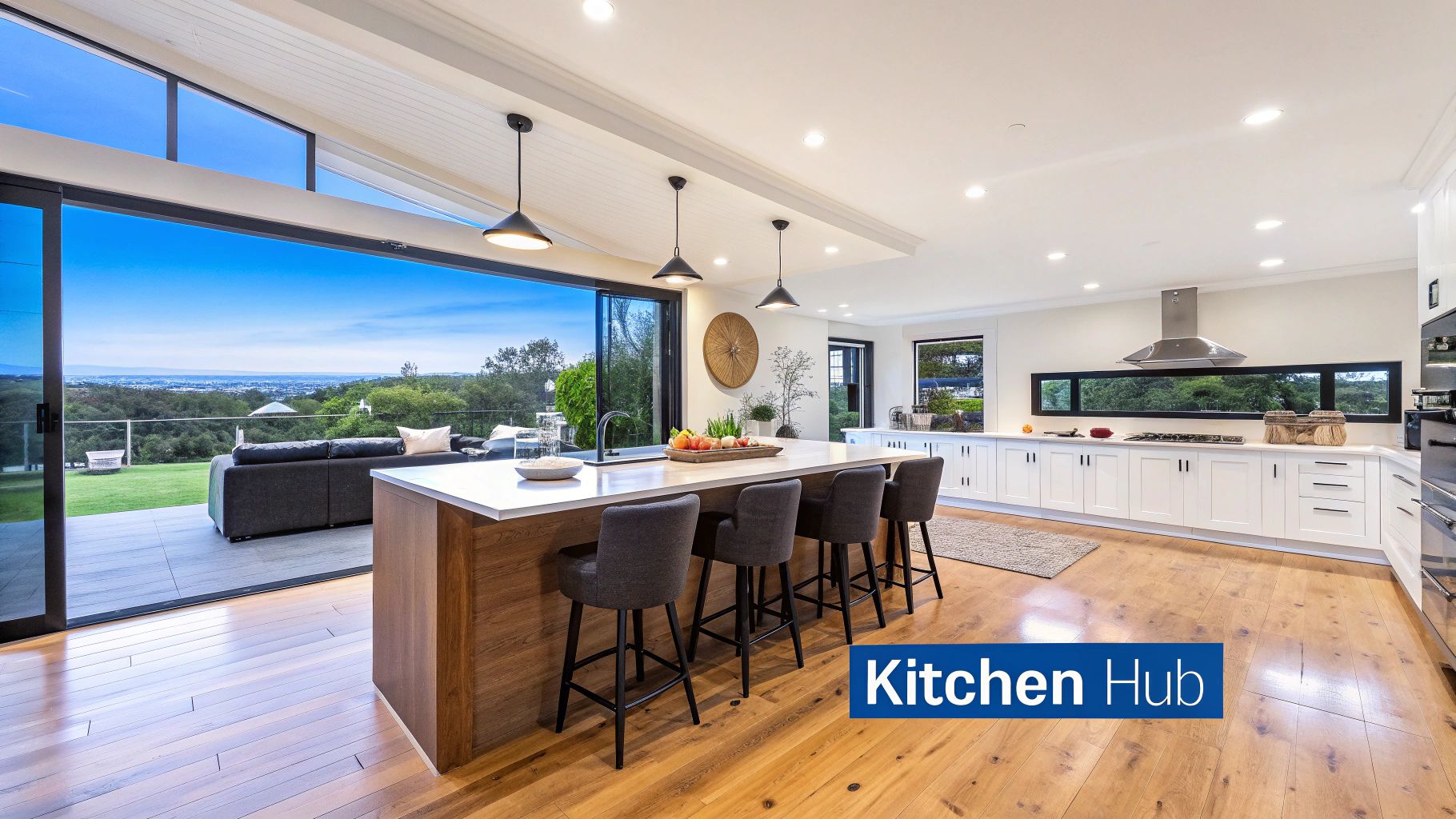 Spacious modern kitchen featuring a large island, white cabinetry, and stunning outdoor views.