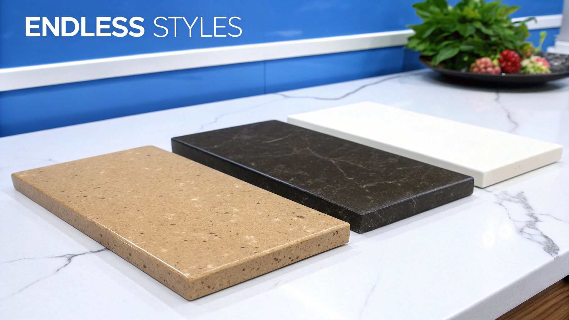 Three quartz countertop samples in tan, dark marbled, and white, displayed on a kitchen counter.