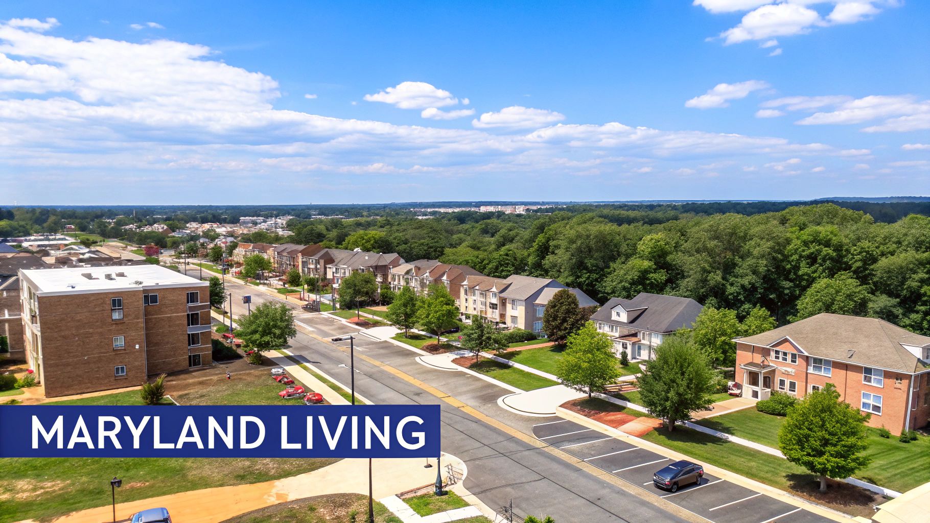 Aerial view of a sunny suburban neighborhood in Maryland with townhouses, streets, and green trees.