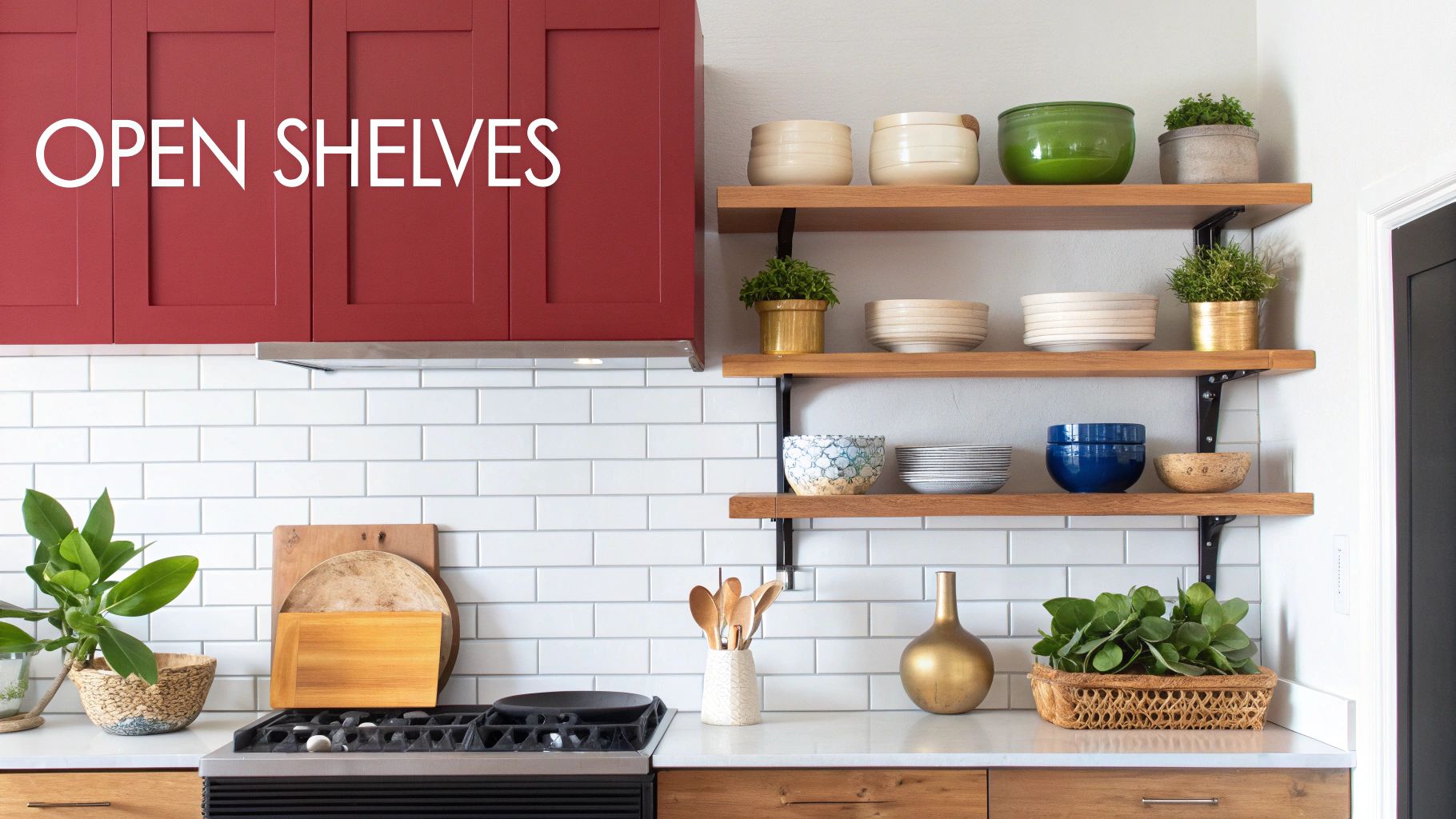 Stylish kitchen featuring bold red cabinets, white subway tiles, and open wooden shelves decorated with plants and bowls.
