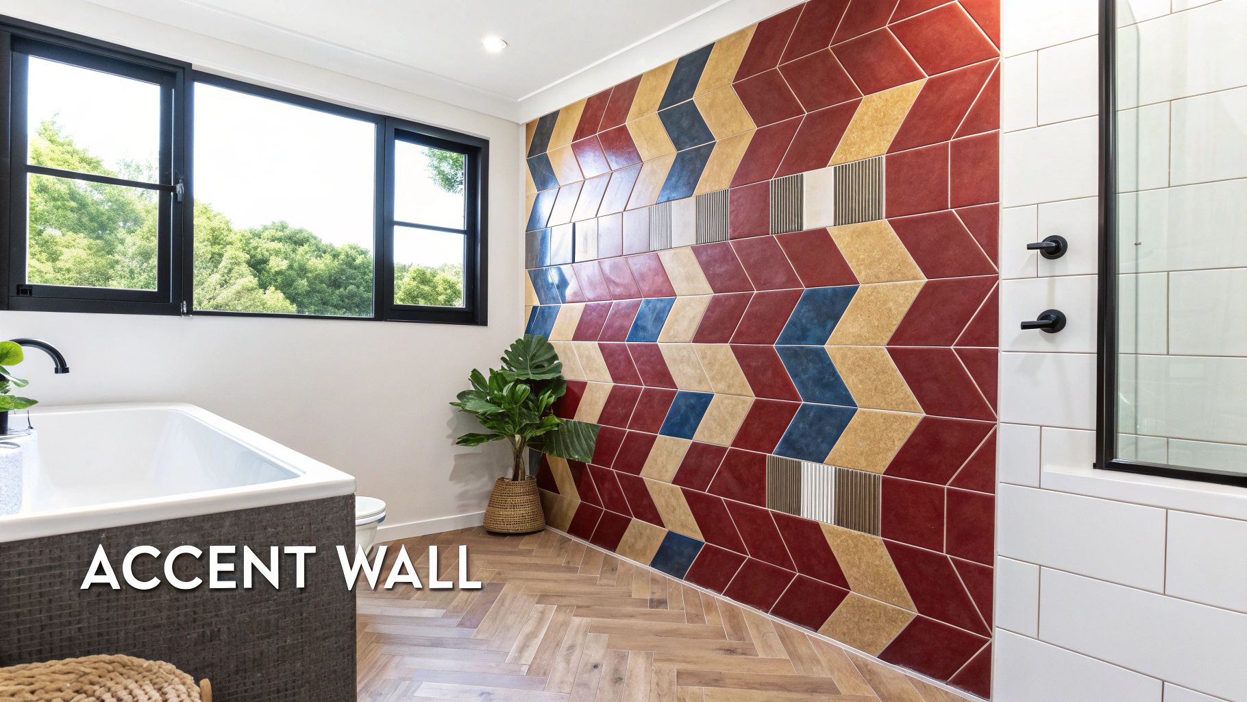 A modern bathroom features a vibrant geometric tiled accent wall, black-framed window, and white tub.